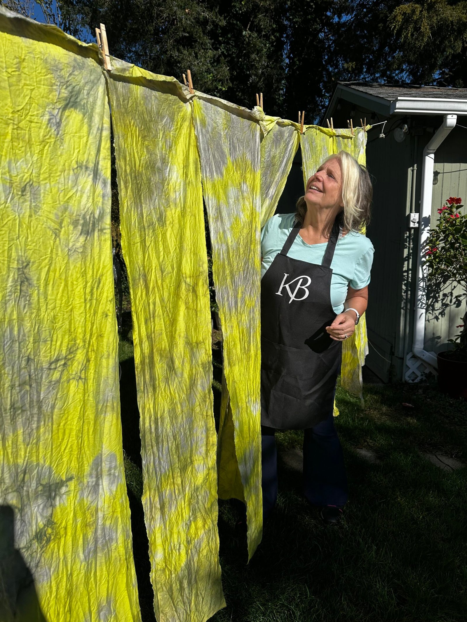 Karen Borga Natural Dye Study Karen Borga hanging naturally dyed fabric samples outdoors