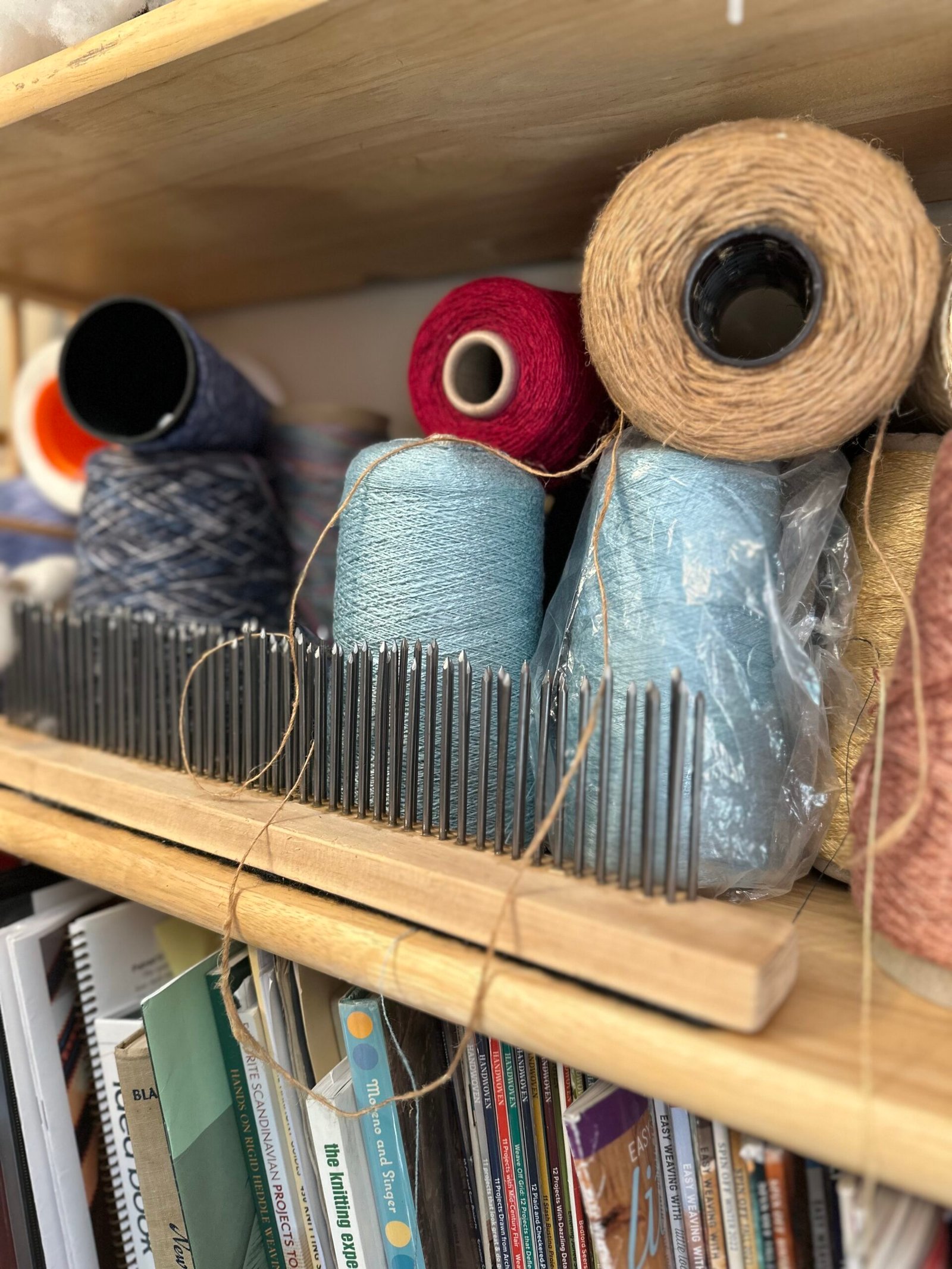 Cones of Yarn in the Studio Shelves of yarn cones and weaving materials in Karen Borga's fiber art studio