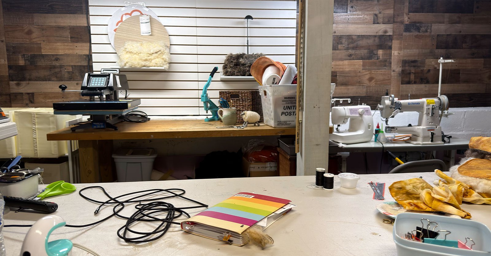 Karen Borga’s fiber art studio workspace with wool, tools, and projects arranged after reorganizing the space.